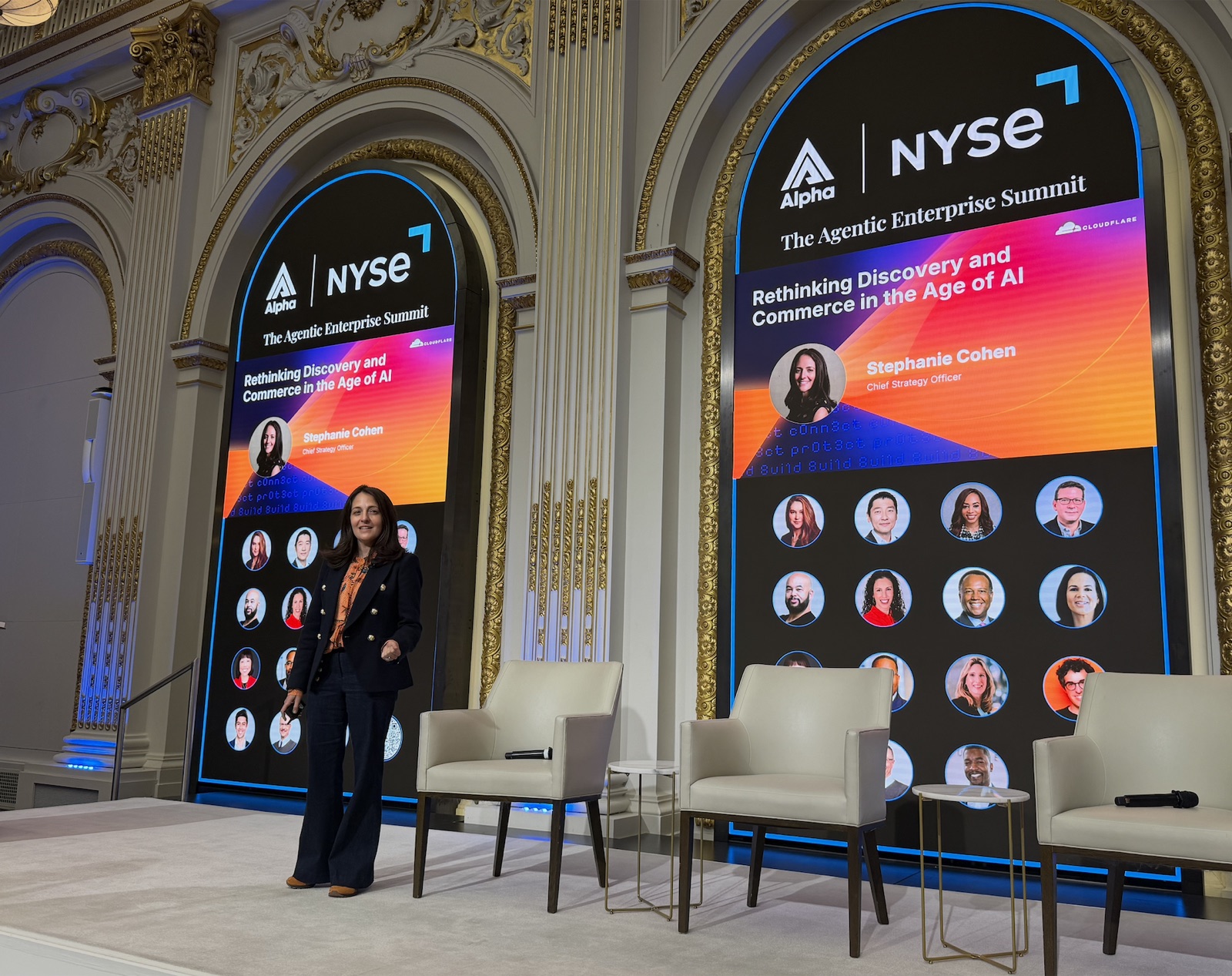Stephanie Cohen onstage beside Alpha and NYSE summit screens.